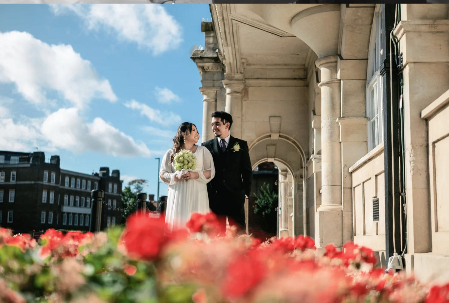 Wedding couple framed by city architecture