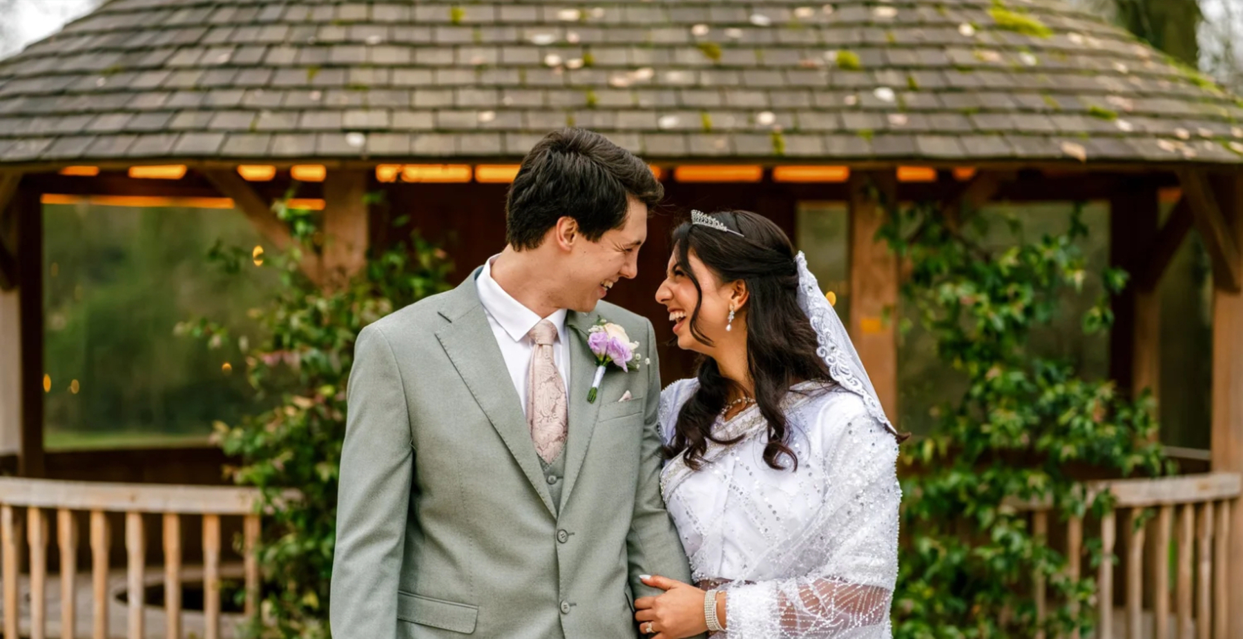 Newlyweds smiling together in a garden