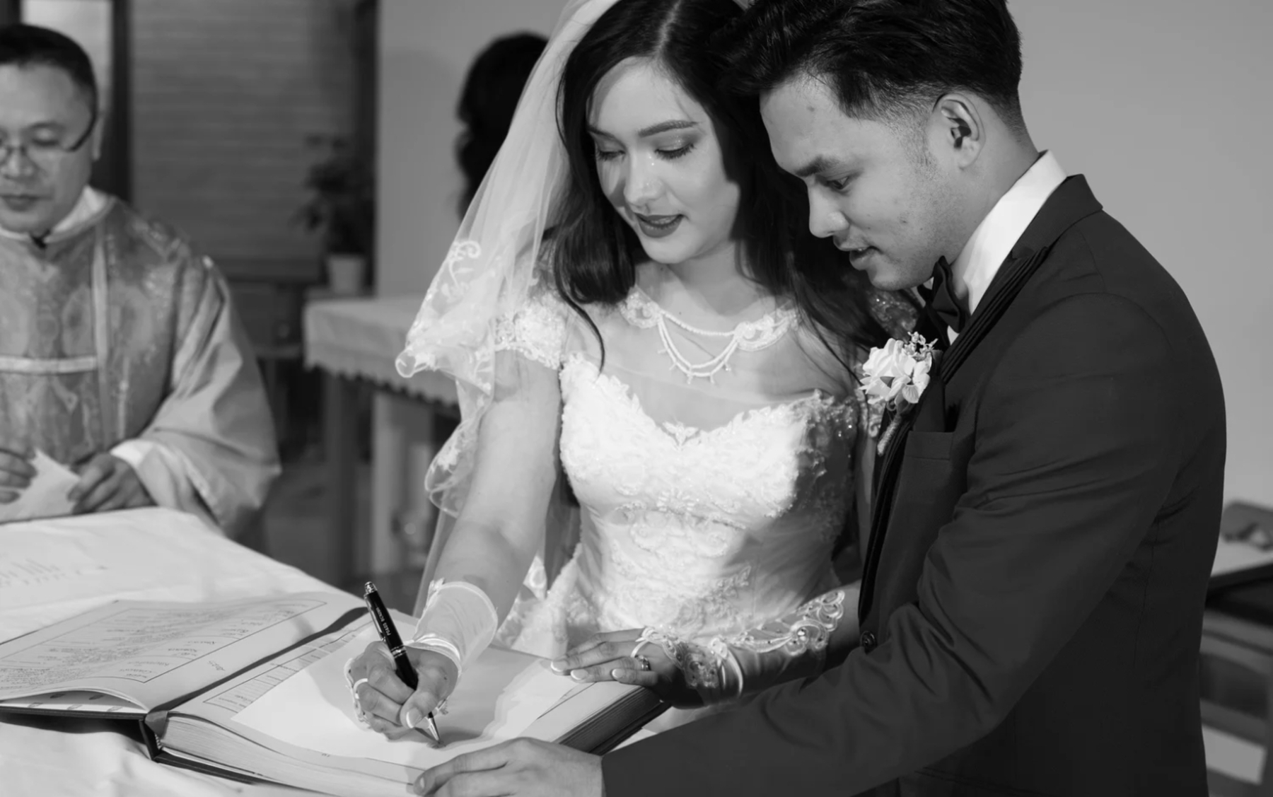 Couple signing their marriage documents